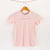 Camiseta rosa de algodón orgánico para niños, estampado a mano con tintas ecológicas. Texto estampado en color naranja. Modelo unisex.