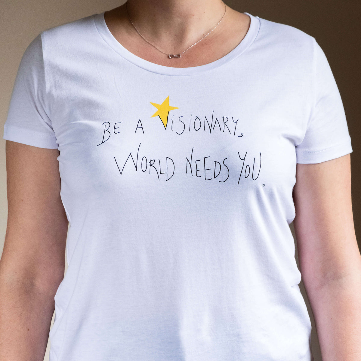 Camiseta blanca de mujer, de algodón orgánico y estampado a mano con tintas ecológicas. Serigrafía en color negro y amarillo.